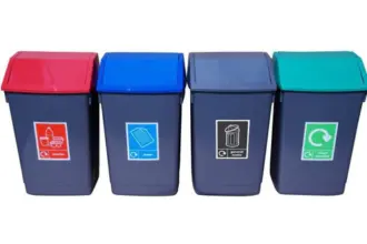 A line of four dark grey bins with angled lids – red for plastics, blue for paper, dark grey for general waste, and green for mixed recycling – each labelled with an icon and text.