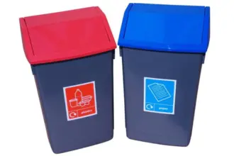 Two dark grey bins with angled lids are shown side-by-side: one with a red lid and a "plastics" label, the other with a blue lid and a "paper" label, both featuring recycling icons.