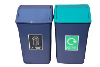 Two dark grey bins with angled lids: one with a dark grey lid labelled "general waste" and the other with a green lid labelled "mixed recycling," both featuring recycling symbols.